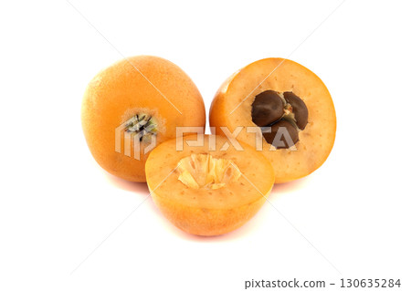 Fresh loquat fruit, whole and cut, showing seeds, isolated on white 130635284
