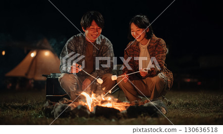 Couple enjoying a bonfire 130636518