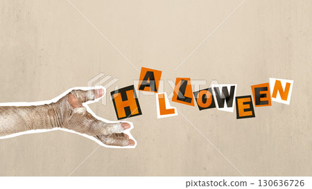 Mummy hand with dirty bandages on them showing text of Halloween on a colored background. Mummy, devil, evil, satan, or zombie hand. Collage art of Halloween 130636726