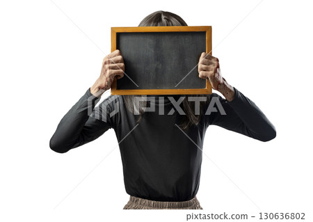 Indonesian southeast asian transgender man dressed as a woman wearing a bloody face mask and holding a blackboard isolated over a white background. Copy space. Concept of Halloween, Sister Hong, or 130636802