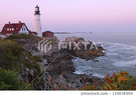 Portland Head Light in late afternoon surrounded by with dramatic waves and cliffs, Maine, USA 130636904