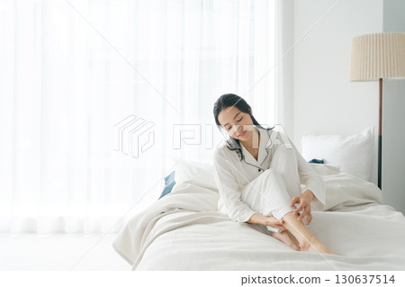 穿著睡衣的女人在床上休息 130637514