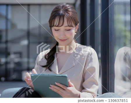Woman operating a tablet Generative AI 130637851