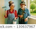 An elderly couple smiles while painting and repairing a room together, holding a paint roller and hammer. Generated AI. 130637967