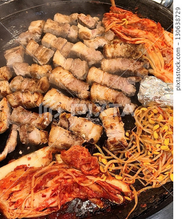 Juicy grilled samgyeopsal paired with spicy, tangy kimchi, offering a perfect harmony of rich, savory meat and bold fermented flavor in every sizzling, mouthwatering bite. Juicy grilled samgyeopsal paired with spicy, tangy kimchi, offering a perfect harmony of rich, savory meat and bold fermented flavor in every sizzling, mouthwatering bite. 130638729