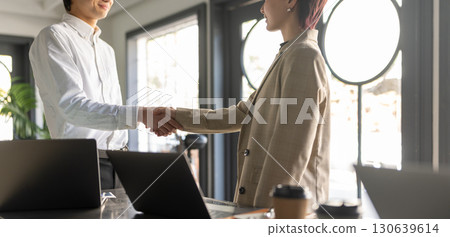 Woman shaking hands with a colleague 130639614