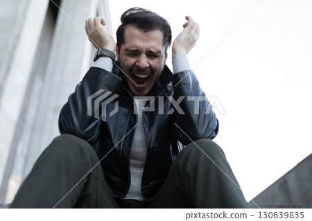 emotional portrait of a man during a panic attack 130639835