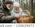 Senior couple enjoying mushroom picking in an autumn forest, holding a wicker basket full of freshly foraged mushrooms, dressed warmly for a cozy outdoor activity together Senior couple enjoying mushroom picking in an autumn forest, holding a wicker basket full of freshly foraged mushrooms, dressed warmly for a cozy outdoor activity together 130639973