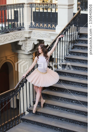 Ballet dancer in tutu posing on elegant staircase Ballet dancer in tutu posing on elegant staircase 130640608