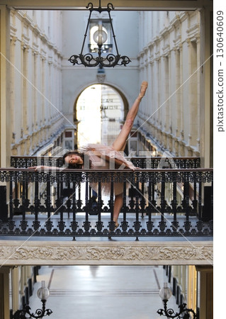 Ballet dancer on balcony in classical archway 130640609
