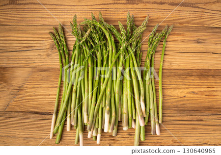 Bunch of Raw Garden Asparagus on Wood Rustic Tabletop. Fresh Green Spring Vegetables 130640965
