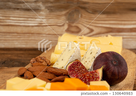 Cheese plate of color cheeses variety, yellow, white and blue cheese board, assorted dairy products Cheese plate of color cheeses variety, yellow, white and blue cheese board, assorted dairy products 130640983