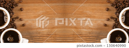 Hot coffee cup and coffee beans on brown background top view 130640990