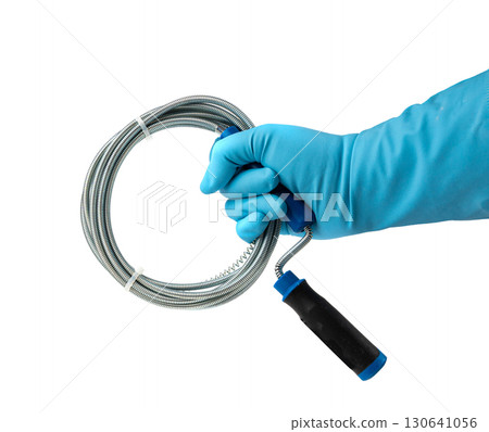 Metal drain auger tool isolated, plumbing snake or cable in hands in blue glove on white background Metal drain auger tool isolated, plumbing snake or cable in hands in blue glove on white background 130641056