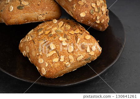 Pumpkin seeds bread, breakfast roll with pepita seeds. Fitness square bun, healthy burger Pumpkin seeds bread, breakfast roll with pepita seeds. Fitness square bun, healthy burger 130641261