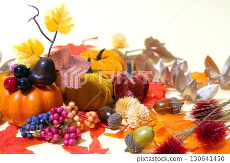 Autumn image background of pumpkins, fallen leaves and nuts 130641450