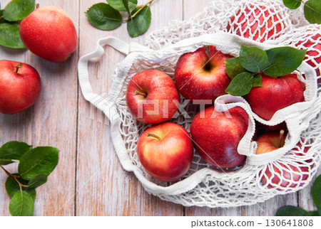 Fresh red apples in reusable shopping bag promoting sustainable lifestyle 130641808