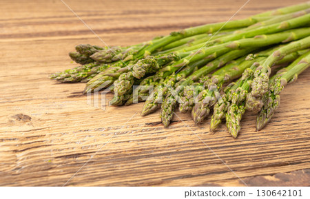 Bunch of Raw Garden Asparagus on Wood Rustic Tabletop. Fresh Green Spring Vegetables Bunch of Raw Garden Asparagus on Wood Rustic Tabletop. Fresh Green Spring Vegetables 130642101