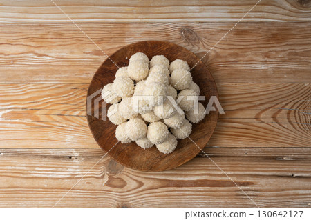 Coconut candies pile, coco ball. White truffle ball, indian ladoo or laddu with sweet cream and coco Coconut candies pile, coco ball. White truffle ball, indian ladoo or laddu with sweet cream and coco 130642127