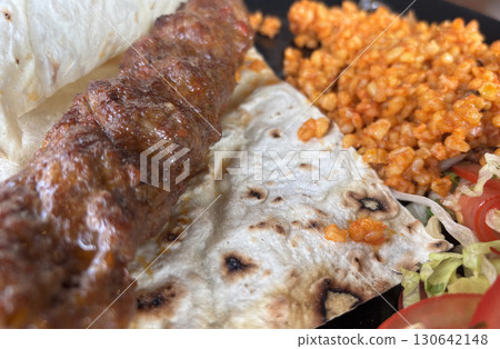 Turkish chicken kebab with bulgur, salad and lavash close up Turkish chicken kebab with bulgur, salad and lavash close up 130642148