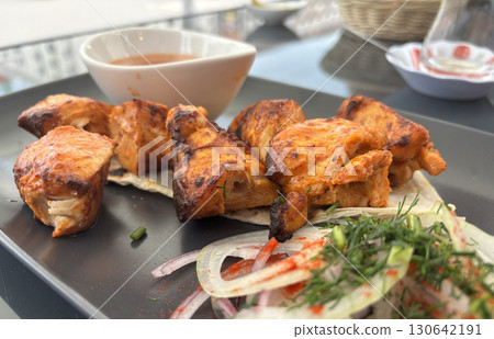 Poultry Shish Kebab, Barbecue Shashlik with Thin Pita Bread and Fresh Vegetables Poultry Shish Kebab, Barbecue Shashlik with Thin Pita Bread and Fresh Vegetables 130642191