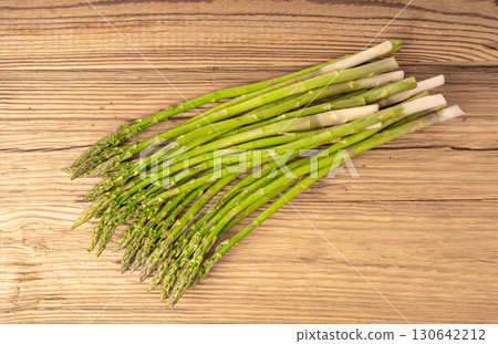 Bunch of Raw Garden Asparagus on Wood Rustic Tabletop. Fresh Green Spring Vegetables Bunch of Raw Garden Asparagus on Wood Rustic Tabletop. Fresh Green Spring Vegetables 130642212