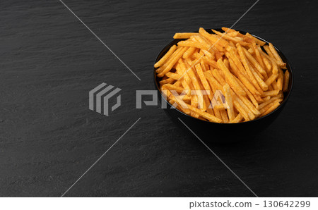 Fried chips sticks, finger potato chips, golden shoestring fries pile, French fries Fried chips sticks, finger potato chips, golden shoestring fries pile, French fries 130642299