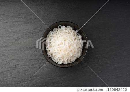 Shirataki or konnyaku pasta in black bowl. Konjak jelly noodles, Japanese zero calorie sirataki 130642420