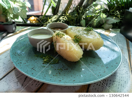 Lithuanian potato dumplings, cepelinai pancakes or kolduny, meat stuffed draniki, traditional didzkukuliai Lithuanian potato dumplings, cepelinai pancakes or kolduny, meat stuffed draniki, traditional didzkukuliai 130642544