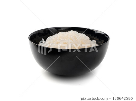 Shirataki or konnyaku pasta in black bowl isolated. Konjak jelly noodles, Japanese zero calorie sirataki Shirataki or konnyaku pasta in black bowl isolated. Konjak jelly noodles, Japanese zero calorie sirataki 130642590