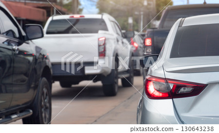 Rear side ov silver car with turn on brake light. Many car queue is full of traffic jams in the city. 130643238