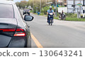 Rear side of grey car turn on brake light. Stop on asphalt road. Opposite of road with motorcycle with driving in city upcountry of Thailand. 130643241