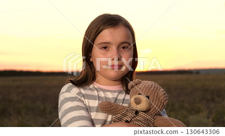 portrait child kid girl daughter teddy bear sunset, children toy meta game, Preteen girl outdoors, toy bear companion, sunset glow, dreamy atmosphere, safe and comfort theme, horizon line, candid 130643306