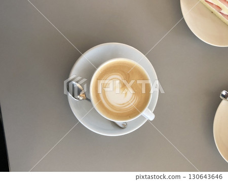 A beautifully crafted latte, featuring creamy foam art on top of rich espresso. Perfect for coffee-related projects, this image captures the warmth and inviting nature of a classic cafe experience. 130643646