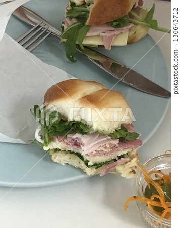 Delicious sandwich filled with fresh ingredients like crisp vegetables, tender meats, and savory spreads, all between two slices of soft bread. Perfect for a quick and satisfying meal. Delicious sandwich filled with fresh ingredients like crisp vegetables, tender meats, and savory spreads, all between two slices of soft bread. Perfect for a quick and satisfying meal. 130643712