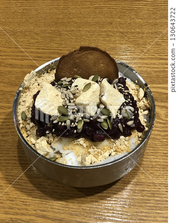 Refreshing patbingsu with fluffy shaved ice, sweet red bean paste, chewy rice cakes, and fresh fruit toppings. A classic Korean dessert, perfect for cooling down on hot days with a delightful taste! Refreshing patbingsu with fluffy shaved ice, sweet red bean paste, chewy rice cakes, and fresh fruit toppings. A classic Korean dessert, perfect for cooling down on hot days with a delightful taste! 130643722