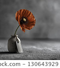 Single orange poppy flower in small ceramic vase with dog tag, minimalist memorial concept for remembrance, honor, and peaceful tribute backgrounds 130643929