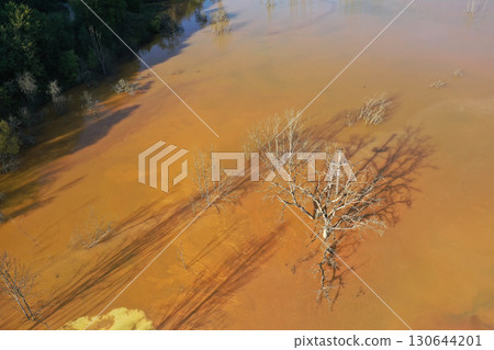 Abstract natural colorful patterns of acid mine drainage in decanting lake aerial view 130644201
