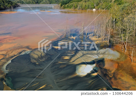 Abstract natural colorful patterns of acid mine drainage in decanting lake aerial view Abstract natural colorful patterns of acid mine drainage in decanting lake aerial view 130644206