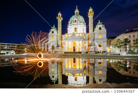 Magical evening view of the St. Charles Church (Karlskirche) and fire show. Location place Karlsplatz in Vienna. Austria, Europe. 130644387