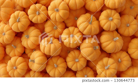 Colorful small orange pumpkins create a lively and festive autumn atmosphere, ideal for seasonal decor Colorful small orange pumpkins create a lively and festive autumn atmosphere, ideal for seasonal decor 130644773
