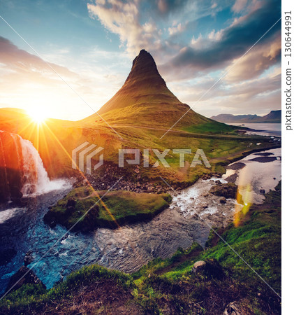 Fantastic evening with Kirkjufell volcano. Location famous place Kirkjufellsfoss waterfall, Iceland, Europe. 130644991