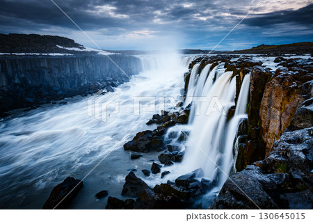 Rapid flow of water powerful Selfoss cascade. Popular tourist attraction. 130645015