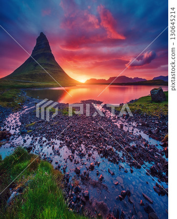 Kirkjufell volcano the coast of Snaefellsnes peninsula. Location famous Kirkjufellsfoss waterfall, Iceland, Europe. Kirkjufell volcano the coast of Snaefellsnes peninsula. Location famous Kirkjufellsfoss waterfall, Iceland, Europe. 130645214