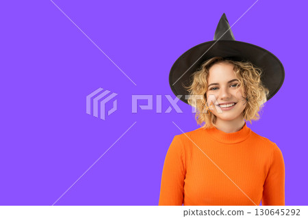 Woman in witch hat and bright top, Halloween ready Woman in witch hat and bright top, Halloween ready 130645292