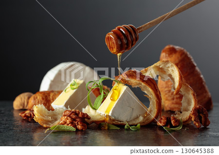 Camembert cream cheese with honey, croissants, and walnuts. 130645388