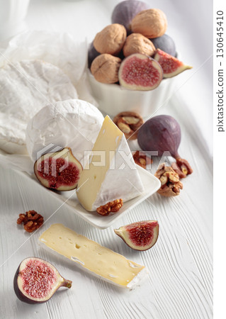 Camembert cheese with figs and walnuts. Camembert cheese with figs and walnuts. 130645410