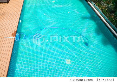 Pool maintenance with scoop net and automatic robot cleaner. Pool maintenance with scoop net and automatic robot cleaner. 130645881