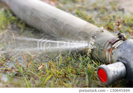 Expired Canvas Water Delivery Hose Cause Water Leaking. Expired Canvas Water Delivery Hose Cause Water Leaking. 130645894