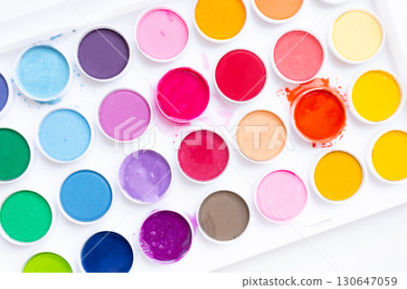 Vibrant watercolor paint set with various bright colors in round containers Vibrant watercolor paint set with various bright colors in round containers 130647059